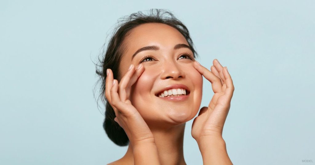 Woman gently touching her face (MODEL)